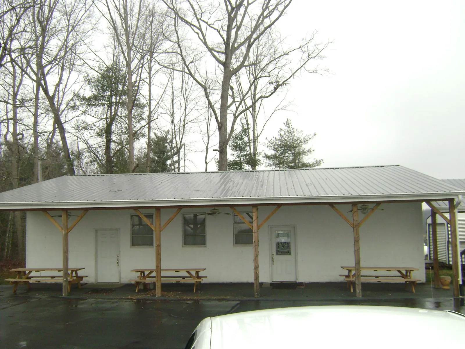 Gray metal roof over a block building with a timber post porch in Columbia Station